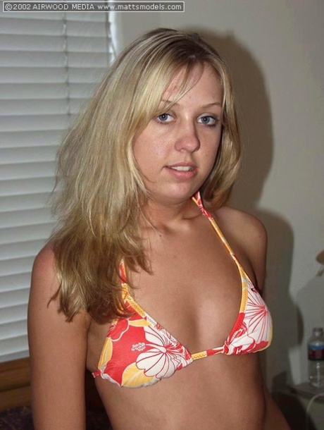 Blonde amateur Sierra doffs a bikini before parting her pink pussy on a bed