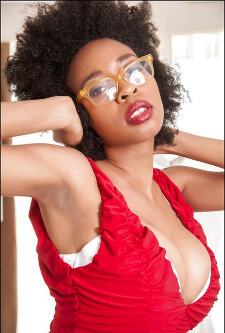 Ebony slut demonstrates her big tits in sexy glasses and red panties