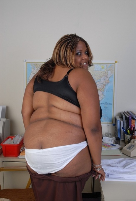 Smiling SSBBW teacher ebony Minxx is undressing in the office