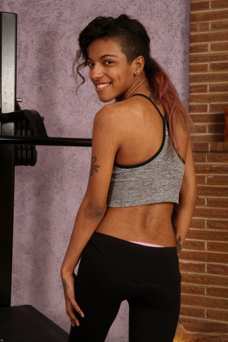 Skinny amateur Yvette reveals her hairy pussy and nice small boobs in the gym