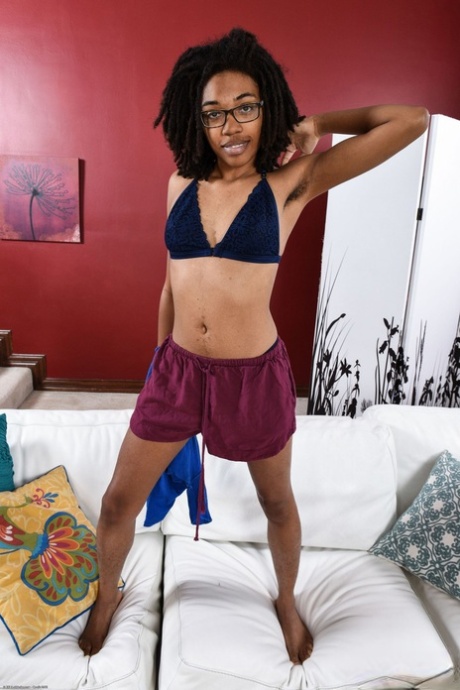 Ebony in glasses Olivia Green reveals her hairy vagina and poses in a solo