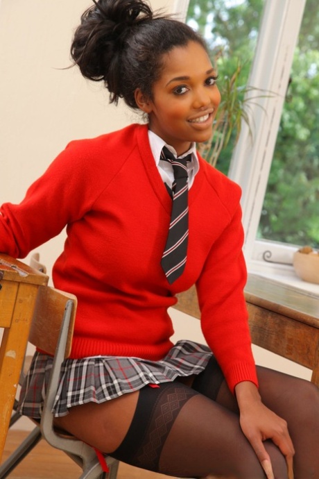 Ebony Rehea flashes her breasts and poses in black stockings in the classroom
