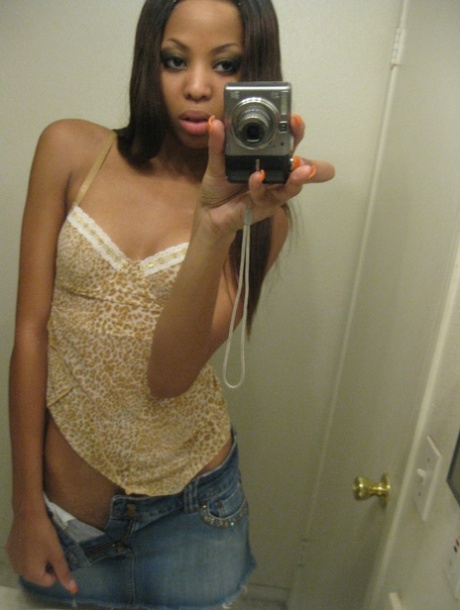 Cute ebony Jazmine takes selfies while stripping & rubbing her pierced cunt