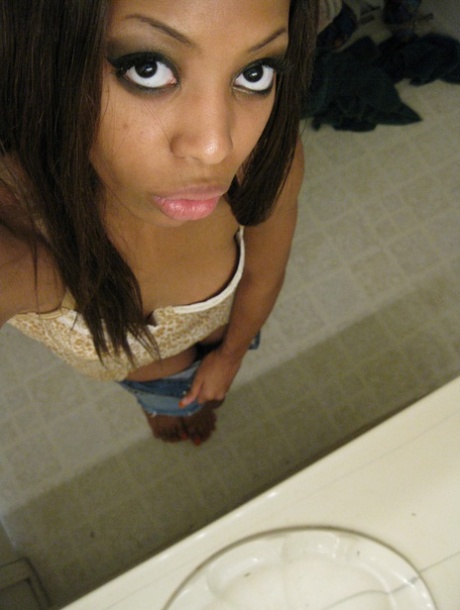 Cute ebony Jazmine takes selfies while stripping & rubbing her pierced cunt