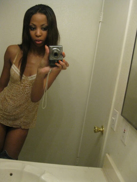 Cute ebony Jazmine takes selfies while stripping & rubbing her pierced cunt