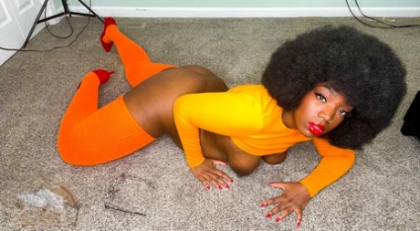 Hot ebony babe with an afro Chy Latte presents her big tits and tasty hole