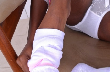 Ebony bombshell Ana Foxxx teasing with her sweet feet & yummy pussy on a chair